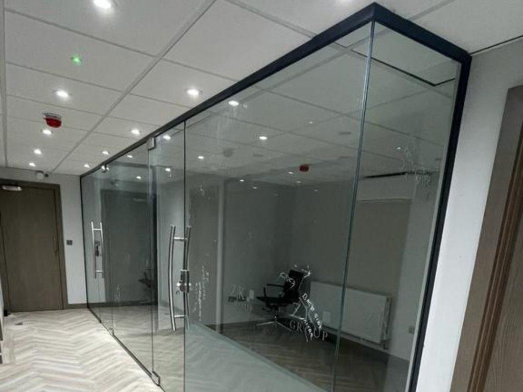 Bespoke glass partition meeting room with frameless glass walls and doors