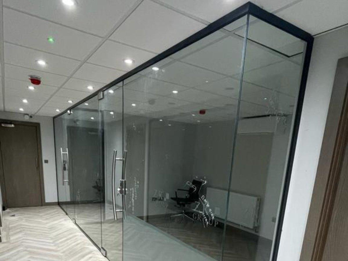 Bespoke glass partition meeting room with frameless glass walls and doors