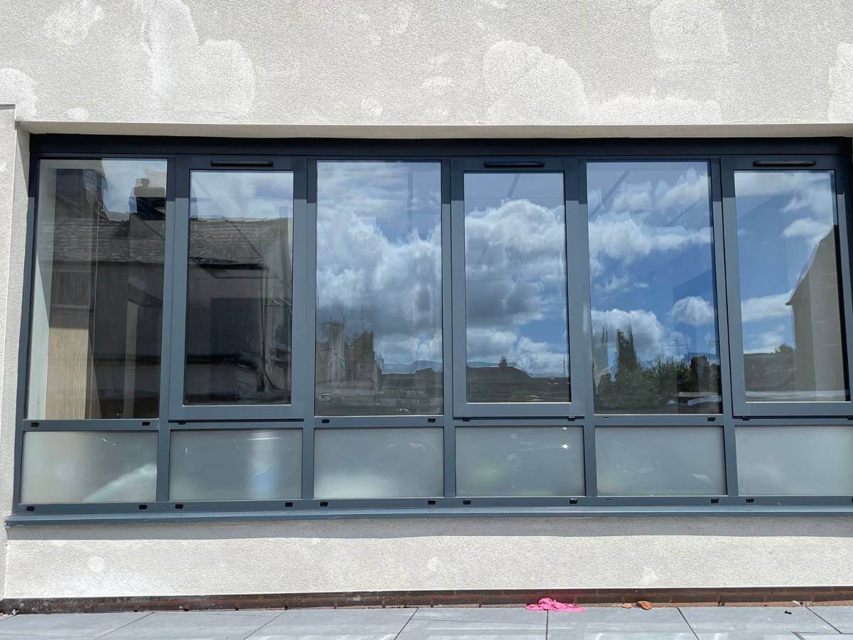 Custom aluminium window system with multiple opening panels fitted in London