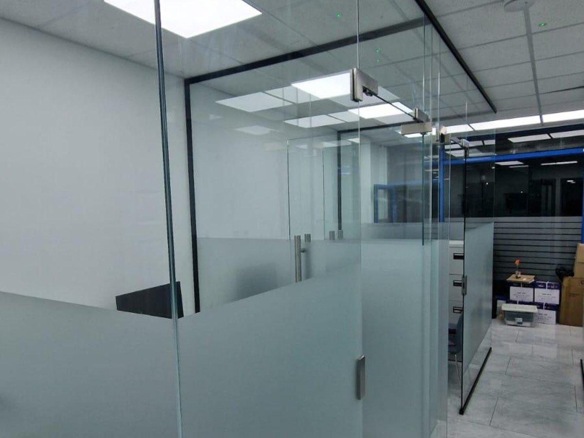 Frameless glass partition system with frosted banding for office privacy