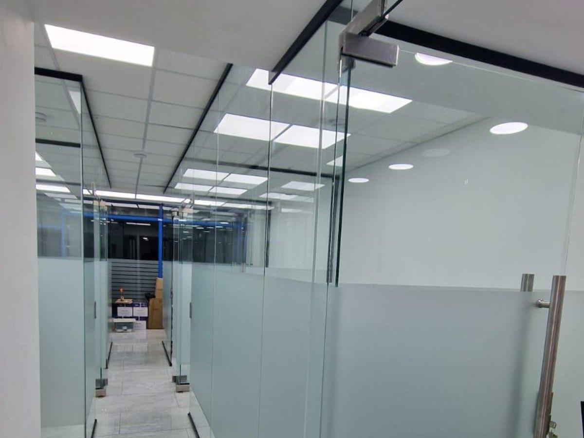 Glass office partitions with soft close glass doors and ceiling track system