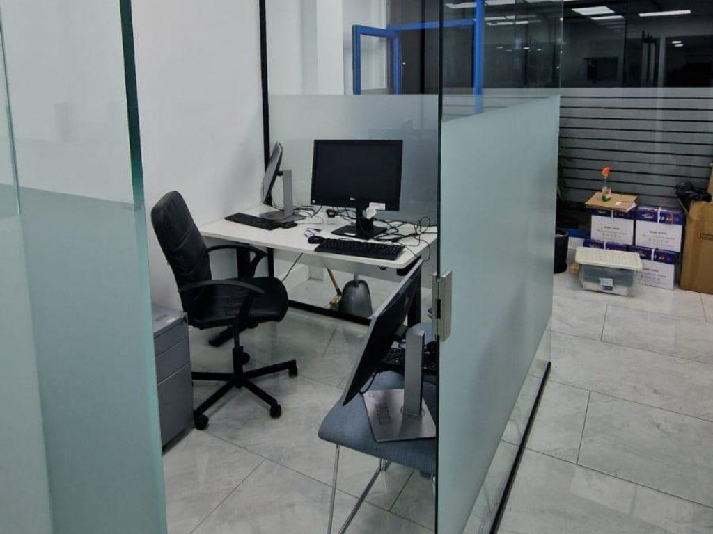 Small glass partitioned office with frosted glass panels and workstation