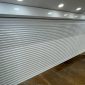 White Perforated Roller Shutter Installation – 12 Broad St Kings Lynn Redwood Shopfront 85x85