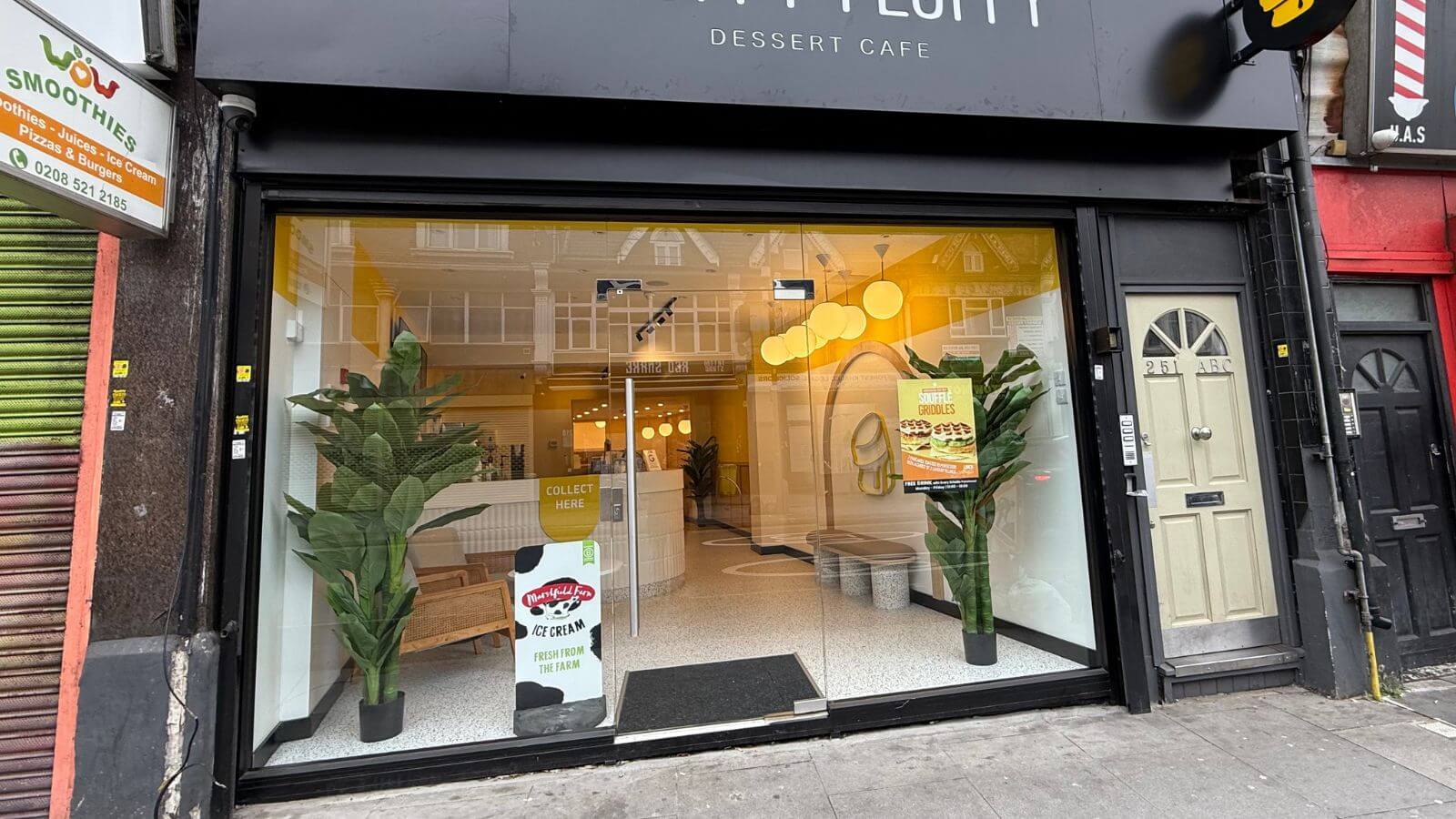 Designer reviewing plans for a frameless glass shopfront for a London business