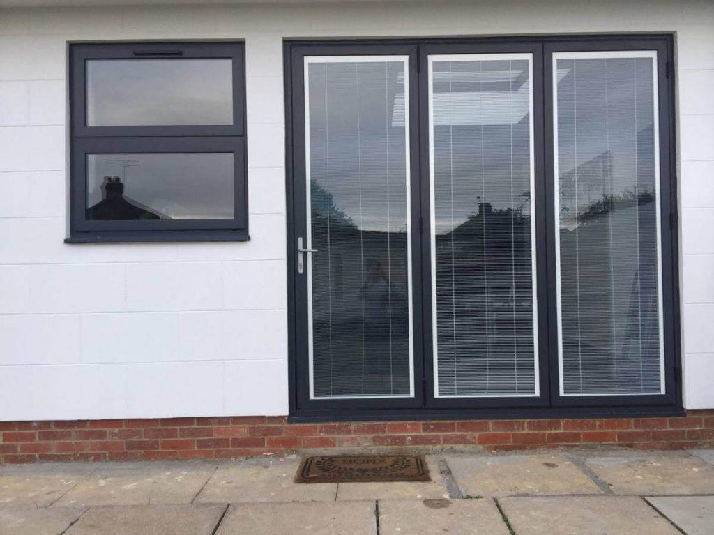 Aluminium bifold doors with integrated blinds fitted to London home extension