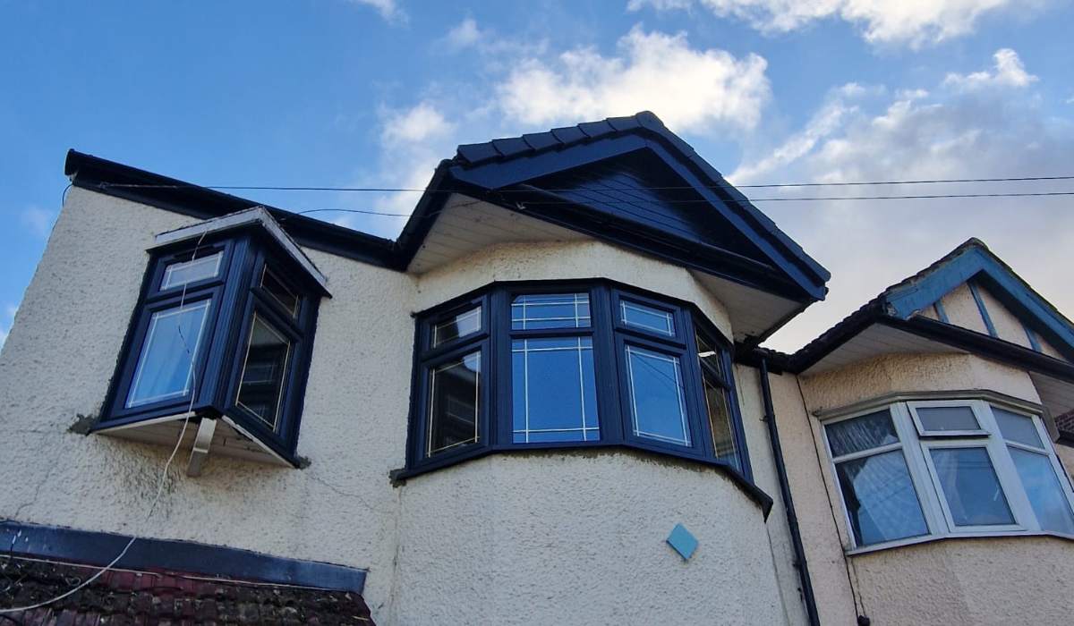 Dark grey uPVC bay and casement windows fitted to the upper floor of a house - Redwood Shopfront