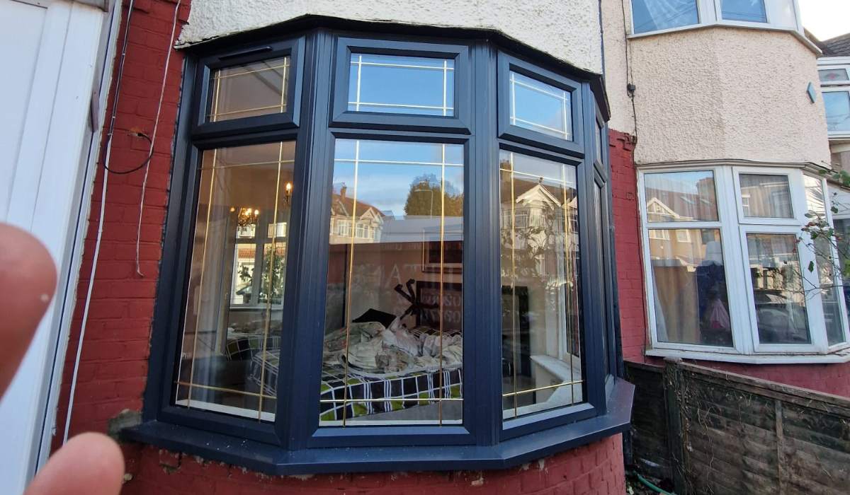 Dark grey uPVC bay window with decorative glazing installed at a residential property - Redwood Shopfront