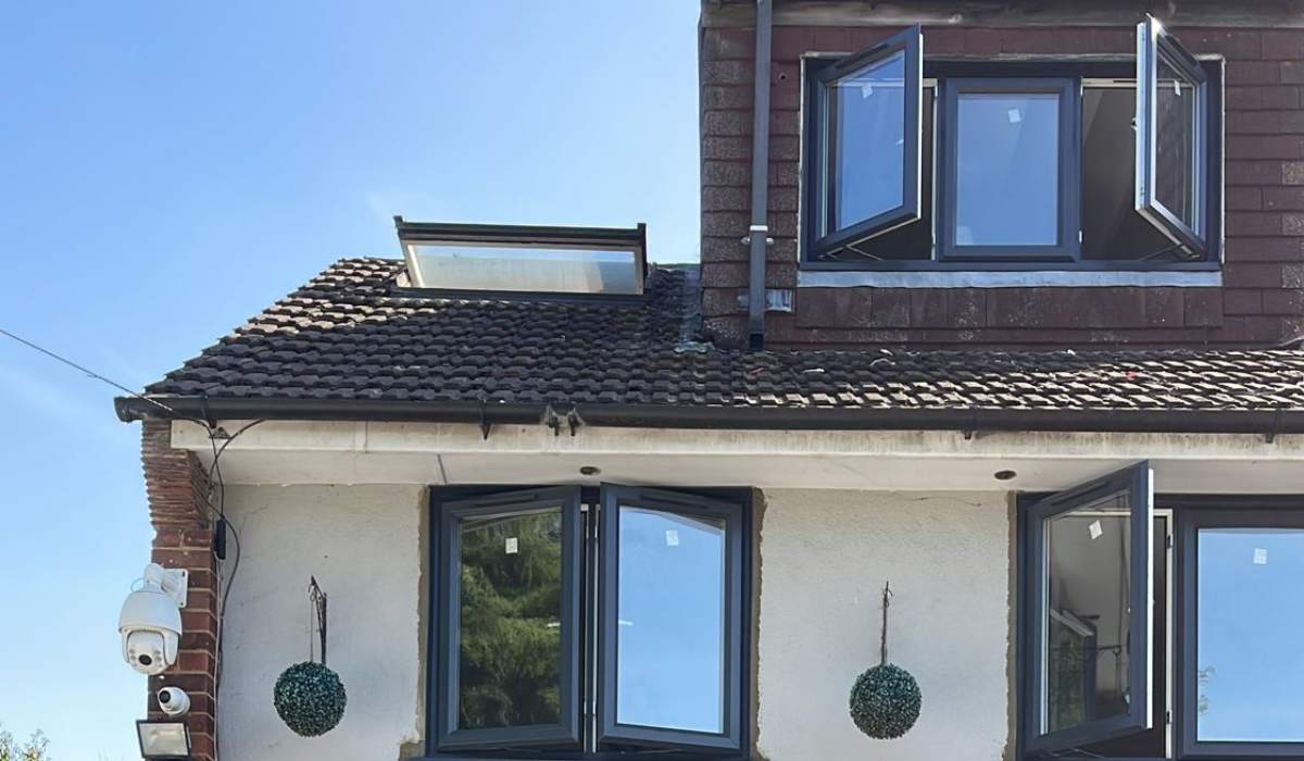 Dark grey uPVC casement windows installed across the front of a residential property - Redwood Shopfront
