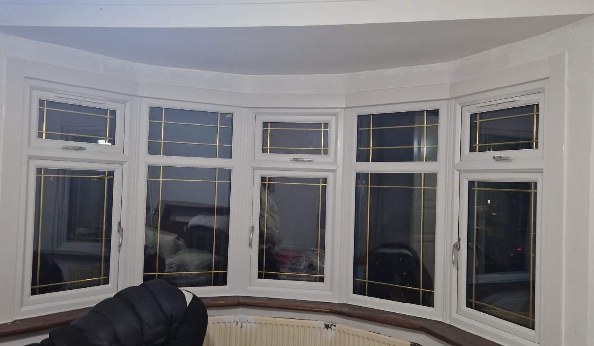 White uPVC bay windows with opening vents and decorative glazing viewed from inside - Redwood Shopfront