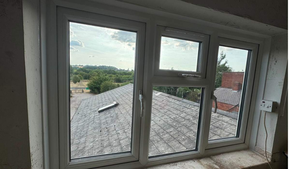 White uPVC window installation with fixed panes and a top-opening centre window - Redwood Shopfront